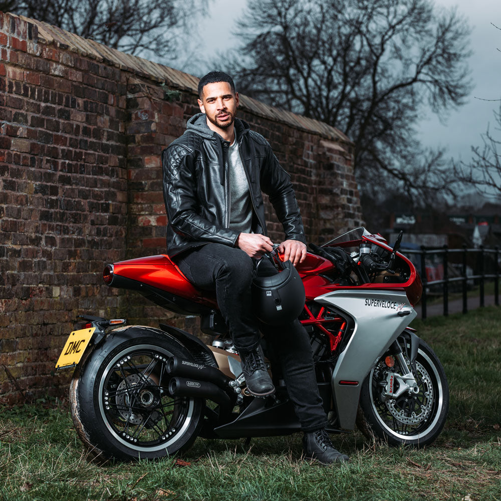 biker on motorbike wearing black leather motorcycle hoodie with hood