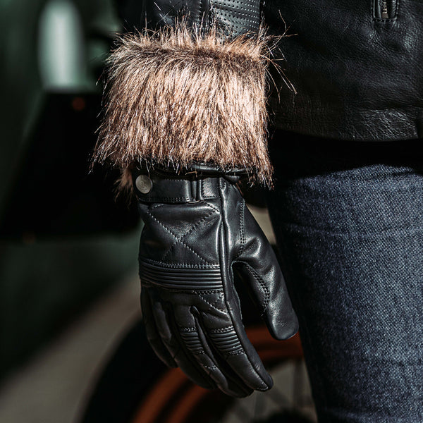 biker wearing black leather gloves for women with matching leather jacket and riding jeans