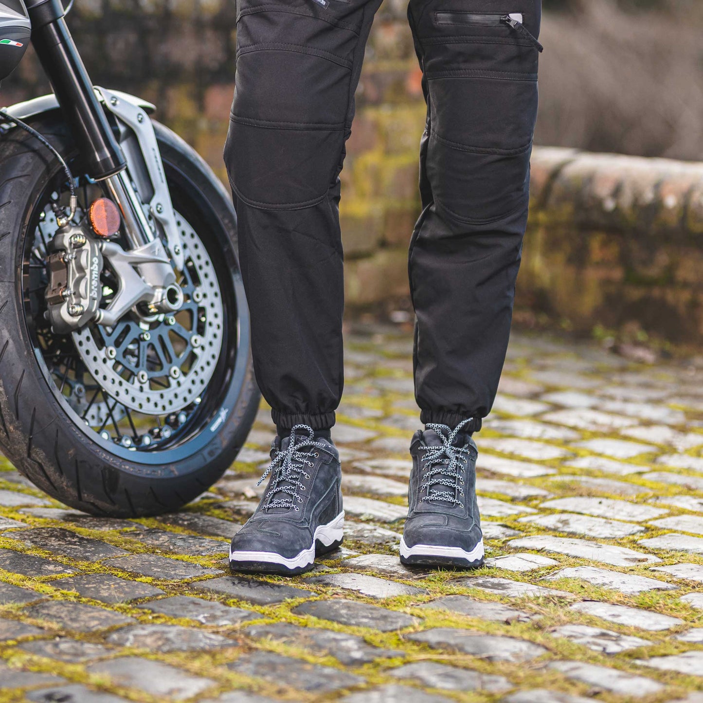 biker wearing black grey motorcycle trainers