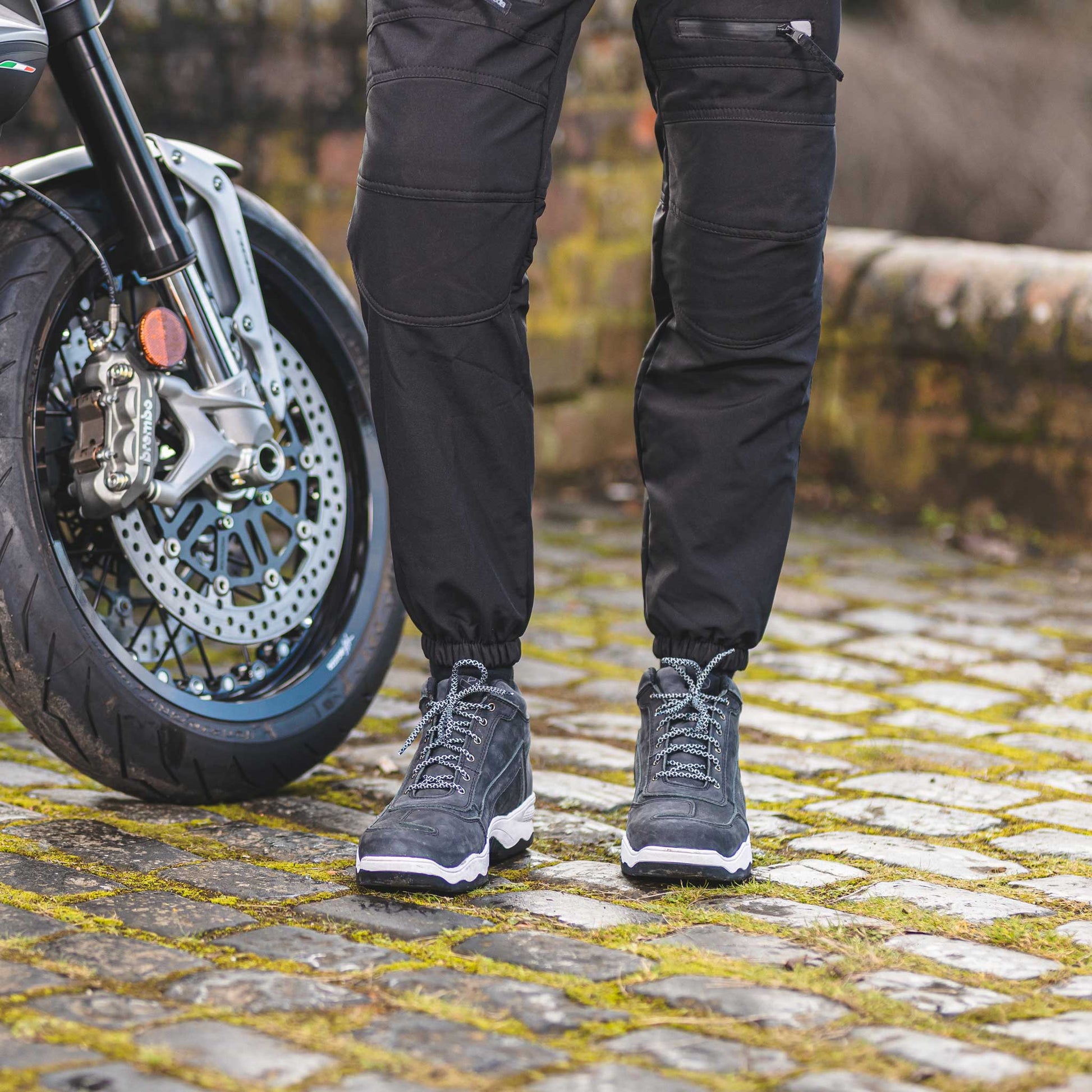 biker wearing black grey motorcycle trainers