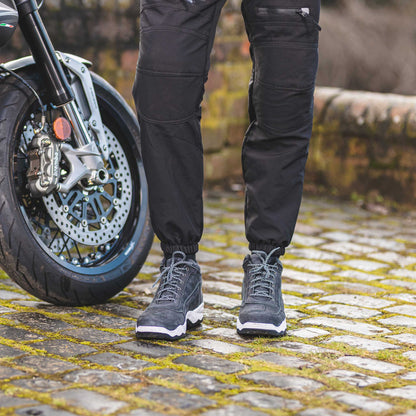 biker wearing black grey motorcycle trainers