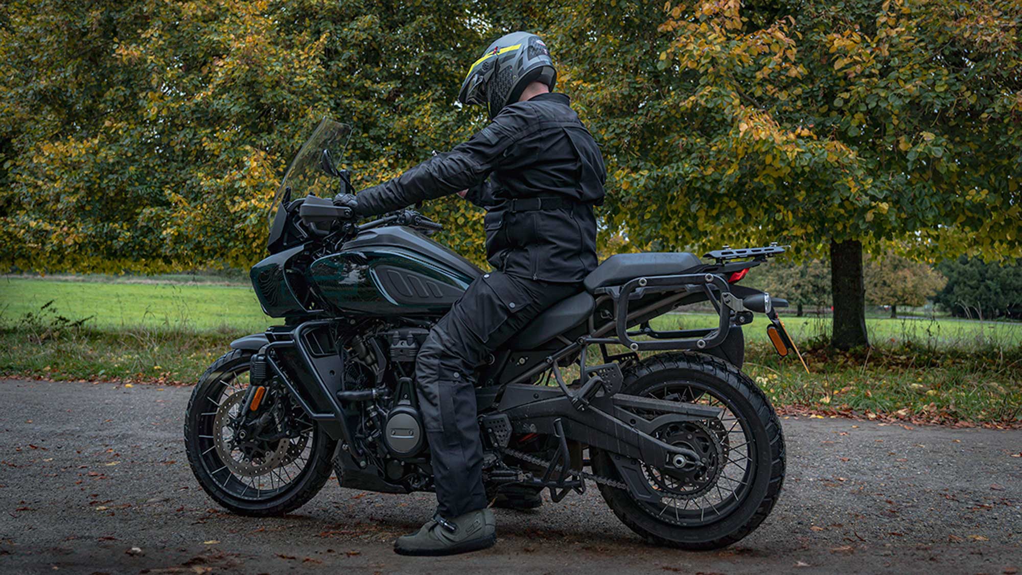 biker on motorbike wearing full black motorcycle gear for men