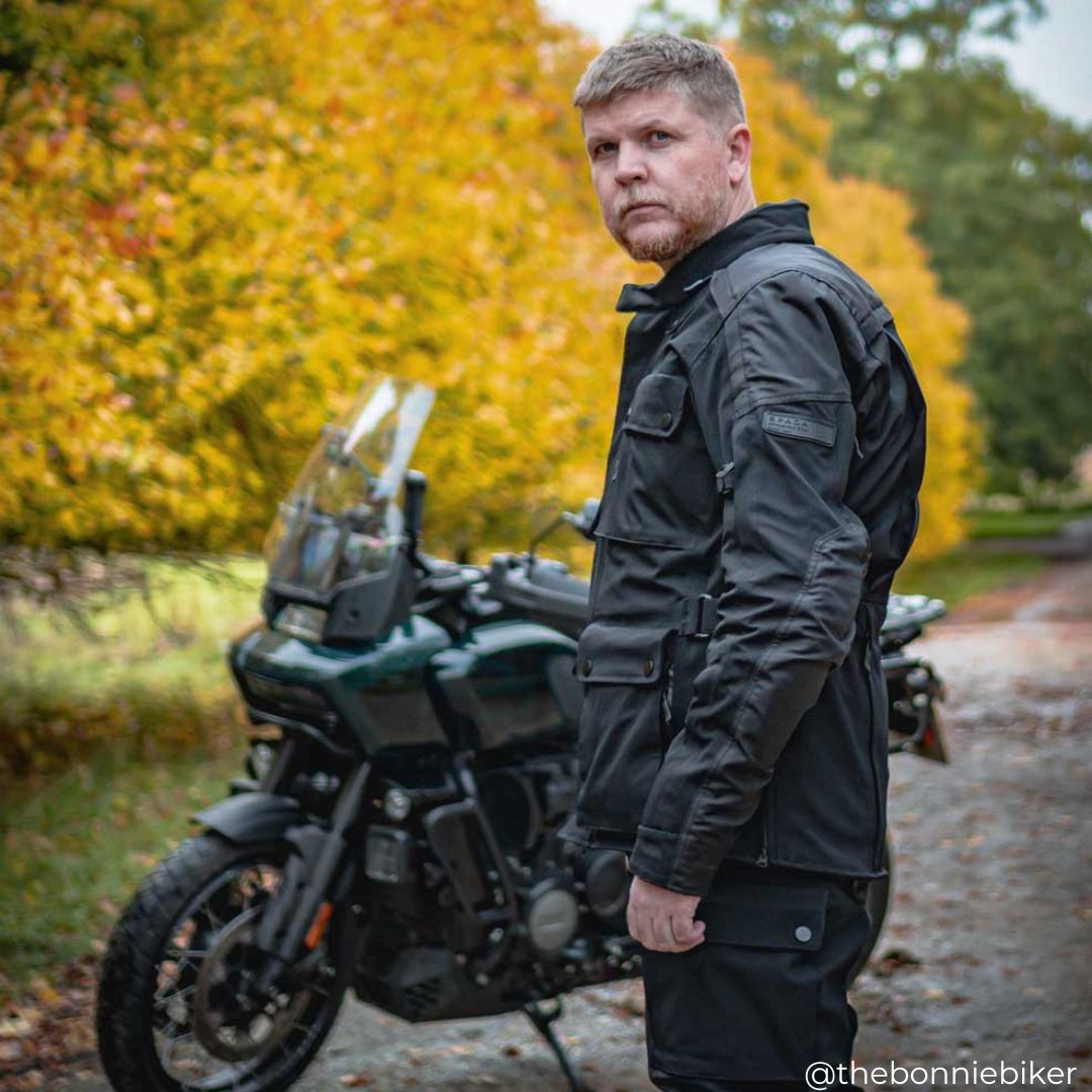 biker wearing waterproof motorcycle jacket with motorbike