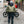 biker walking towards motorbike wearing motorbike gear including green jacket