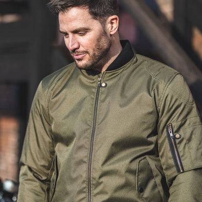 motorcyclist wearing olive green motorcycle bomber jacket for men