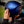 back of biker flipping visor on matt blue motorbike helmet