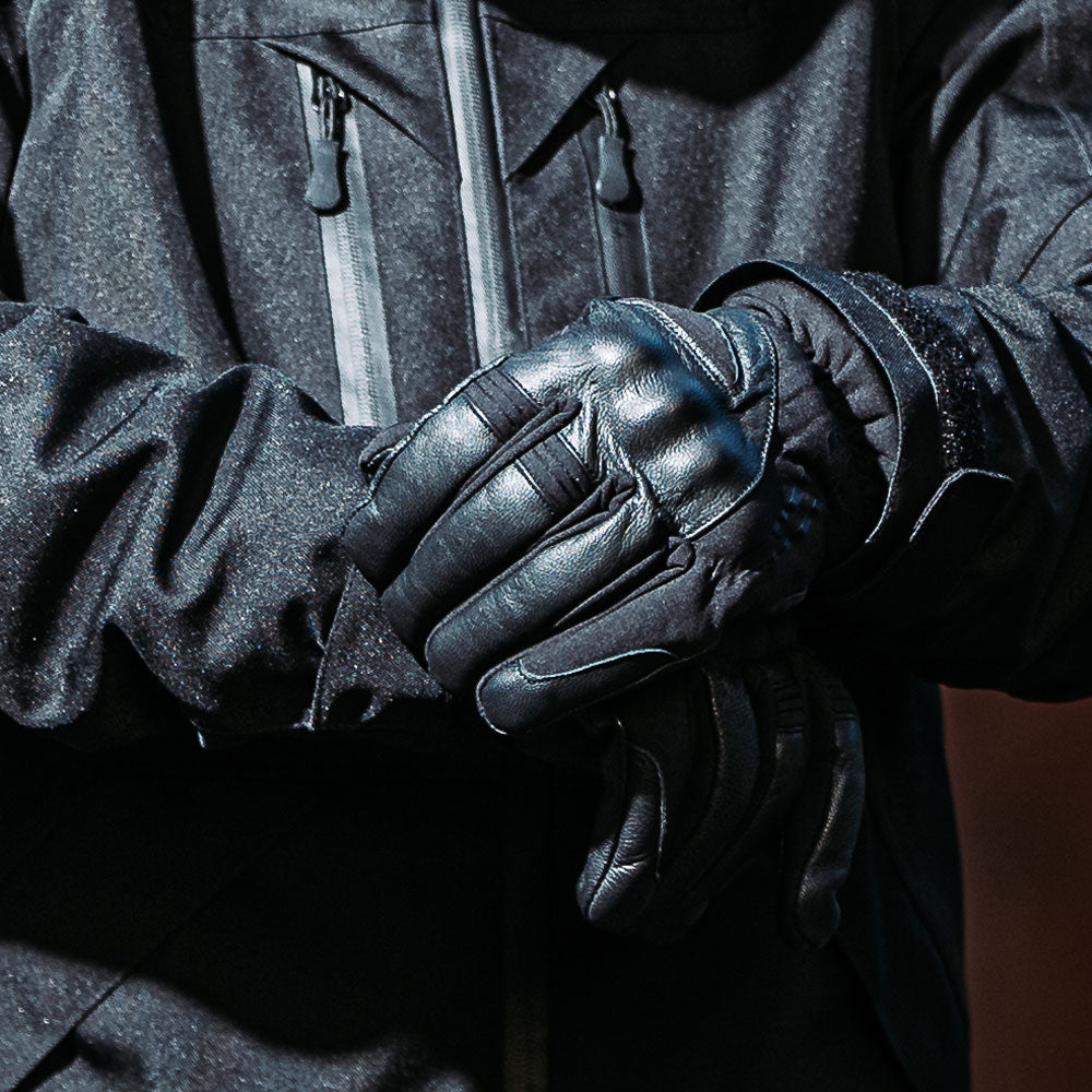 biker in all black wearing black leather motorcycle gloves with thermal insulation