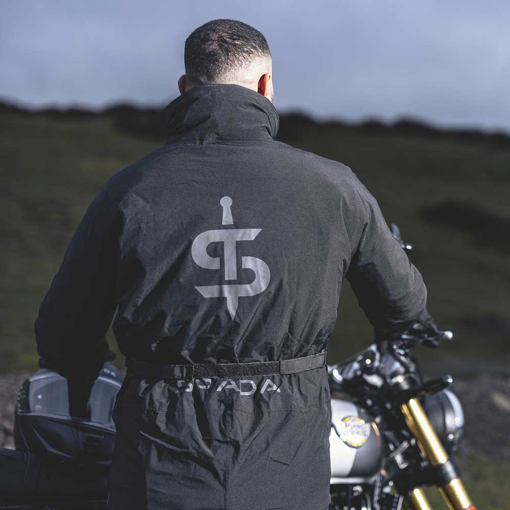 back of black motorbike oversuit jacket and trousers with spada reflective print