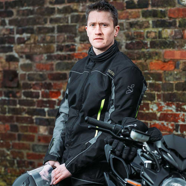 biker wearing black motorcycle jacket on bike