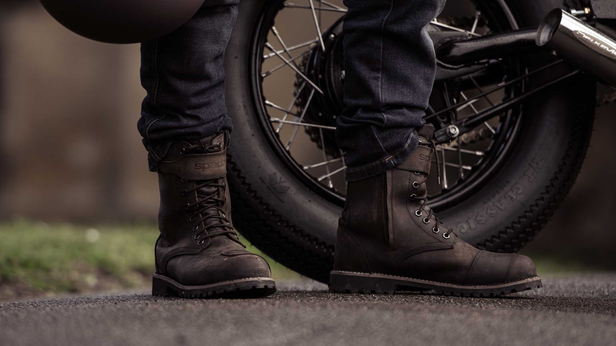 biker wearing brown rugged motorcycle boots with motorbike