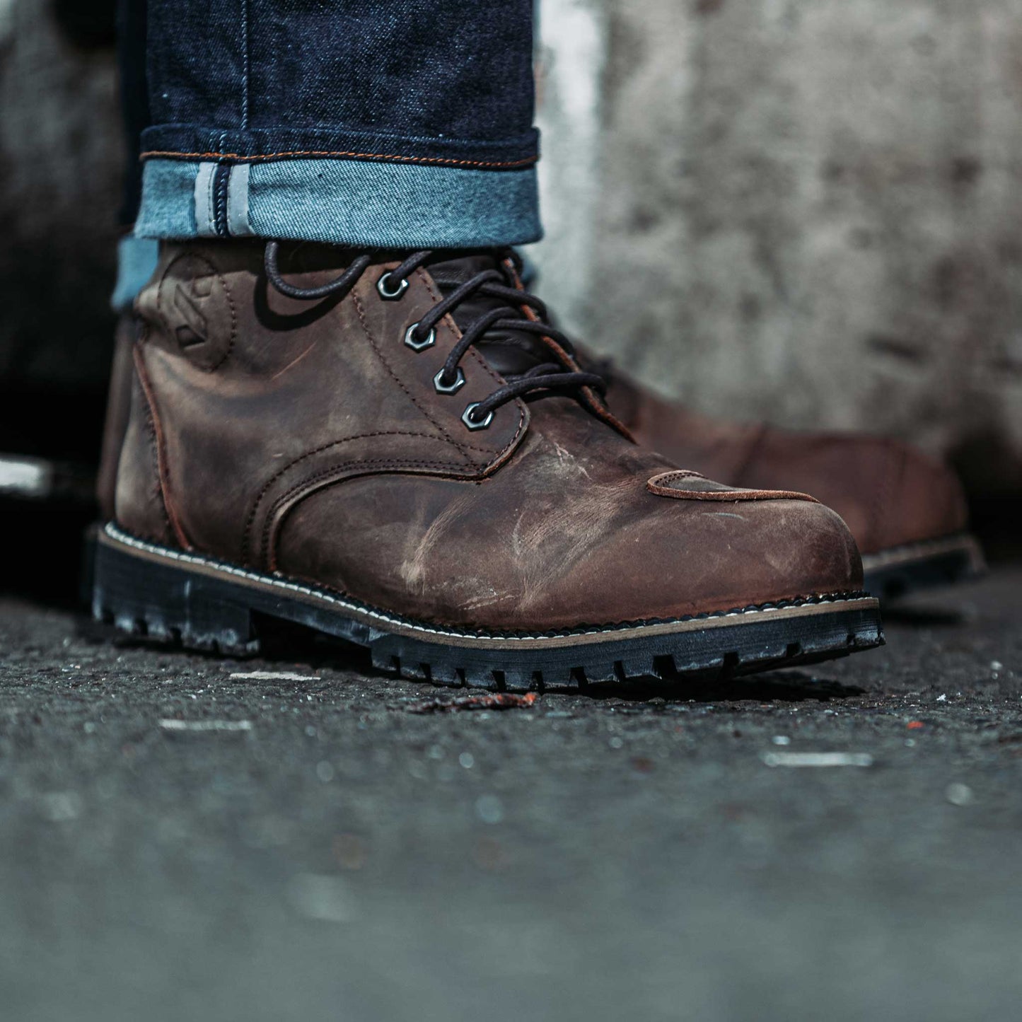 closeup of distressed brown motorbike boots for men