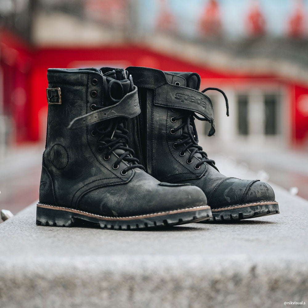 pair of black distressed motorcycle boots for men after being worn on ride