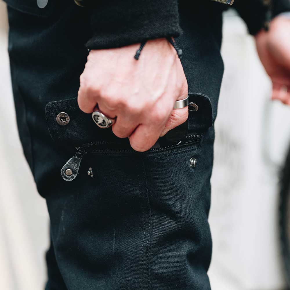 closeup of cargo side zip pocket on black pants