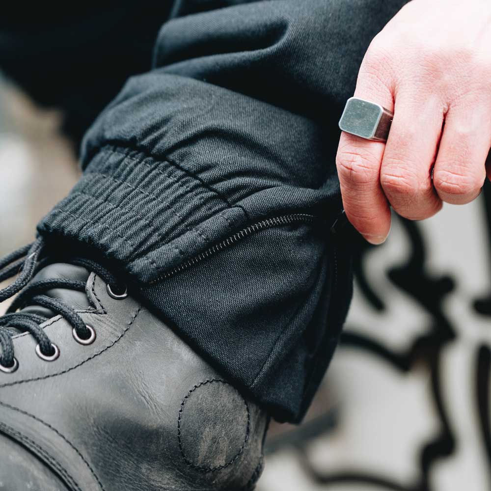 closeup of cuff and zipper on black mens trousers for bikers