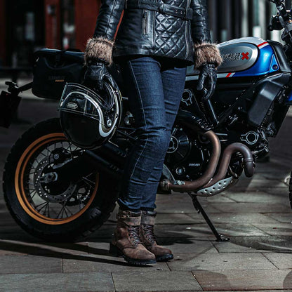 woman biker wearing brown leather motorcycle boots with leather jacket and jeans on motorbike