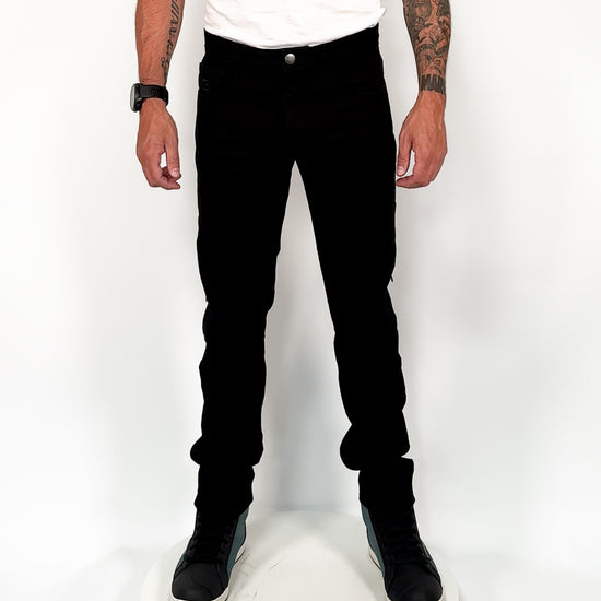 360-degree view of a man wearing men’s solid black motorcycle jeans, showcasing the slim fit, protective armour, and full styling from all angles.