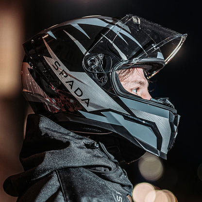 side view of biker wearing black and grey full face motorcycle helmet with visor flipped up