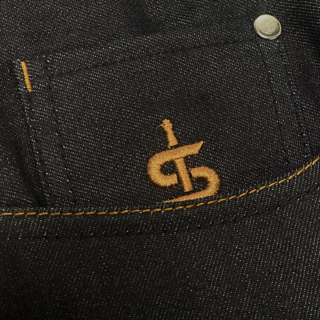closeup of pockets on raw denim jeans for women