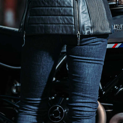 back of womens blue raw denim motorcycle jeans
