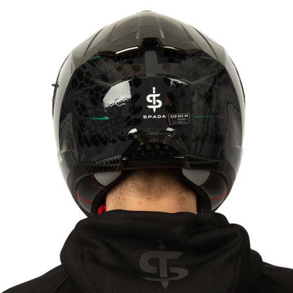 back of black and green patterned motorcycle helmet with design