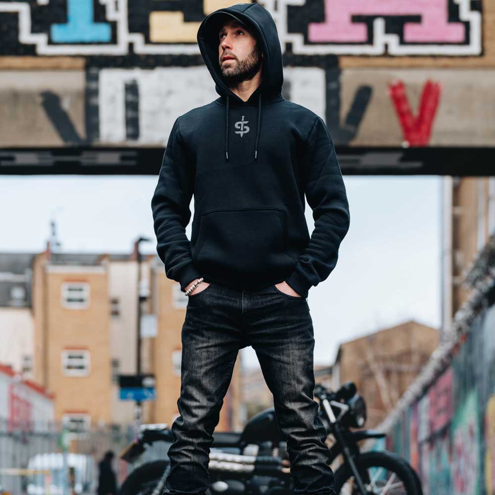 biker wearing black spada casual hoodie with motorbike in background