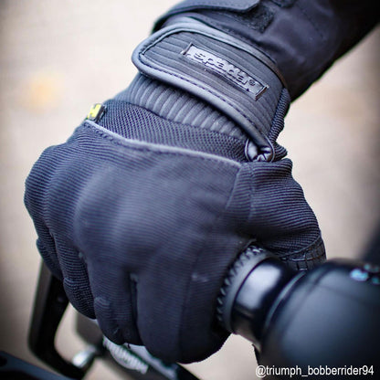 biker wearing textile black motorcycle glove on a ride