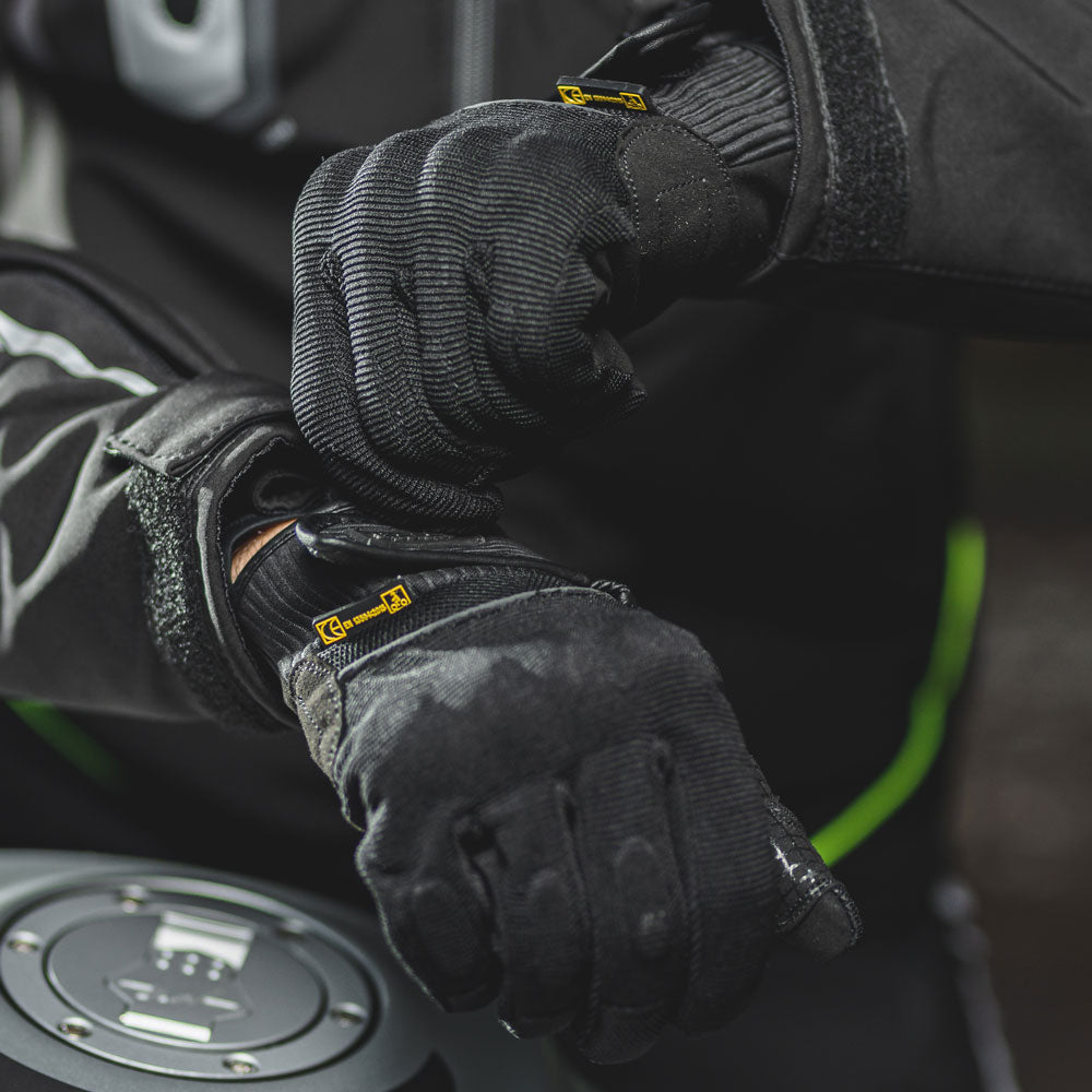 biker wearing black textile motorcycle gloves on a ride