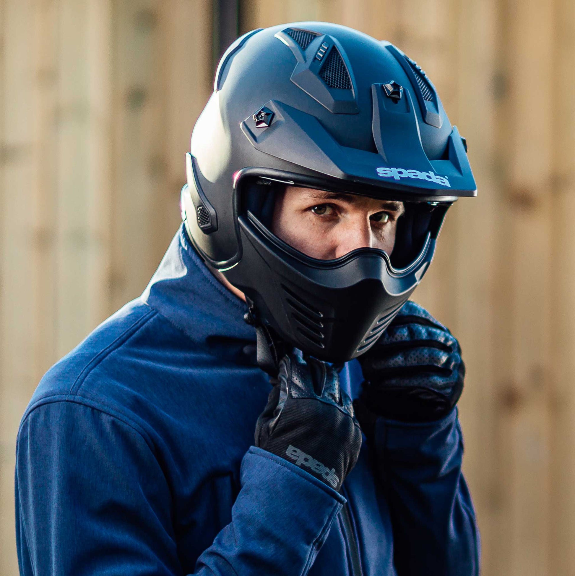 biker putting on matt black open face helmet