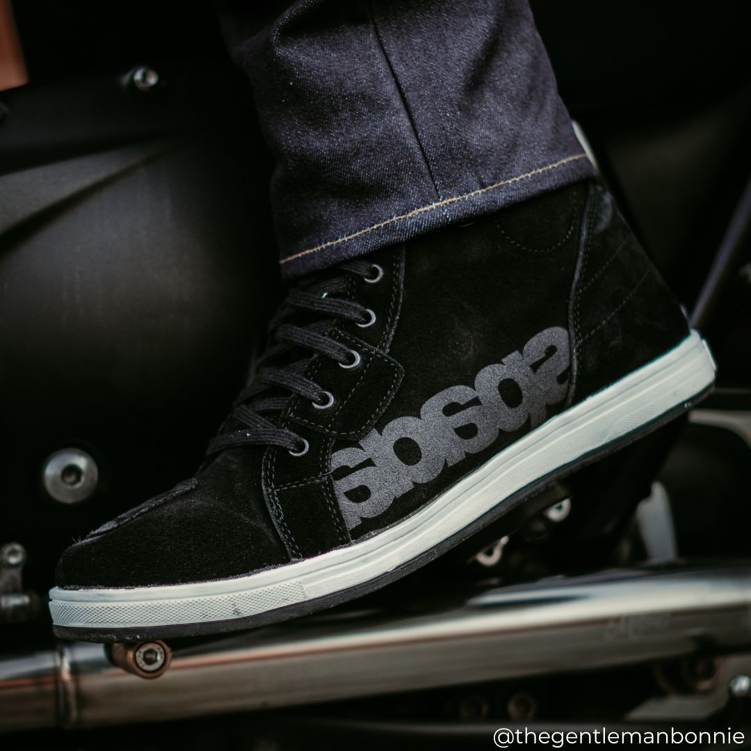 biker wearing black motorbike shoes with motorbike jeans on motorcycle