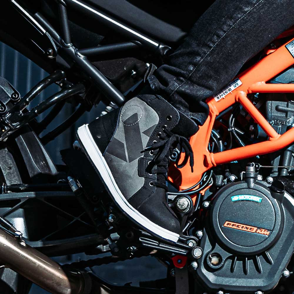 biker wearing black and grey motorbike trainers with gear pad