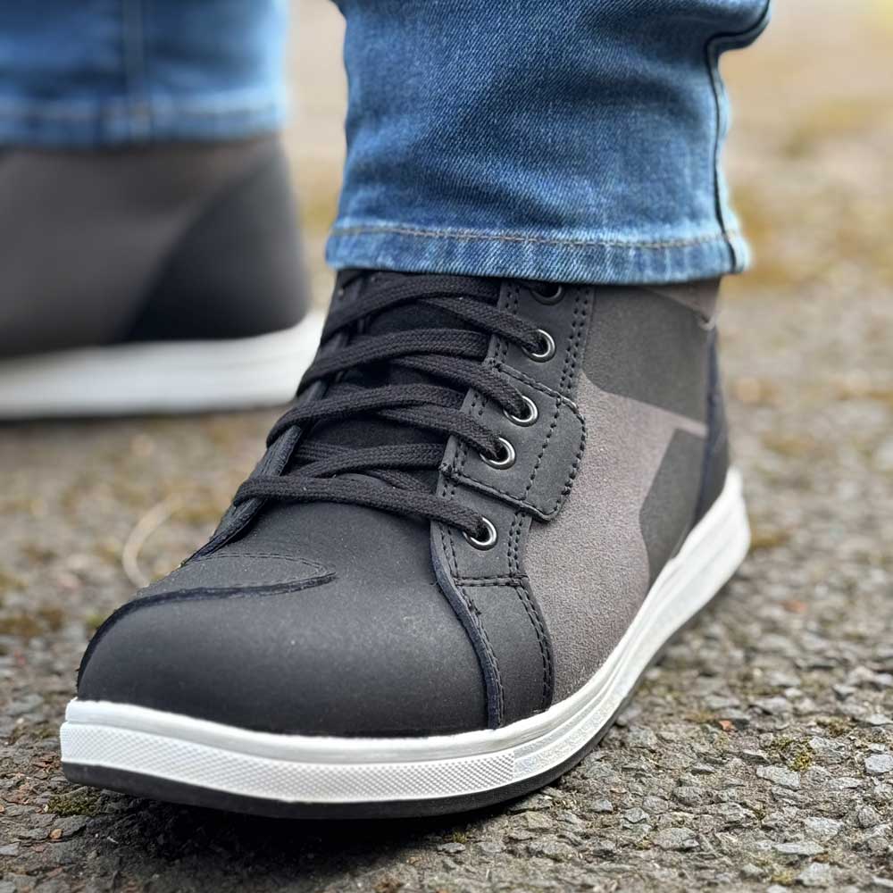 close up of black motorbike trainers with gear changing pad