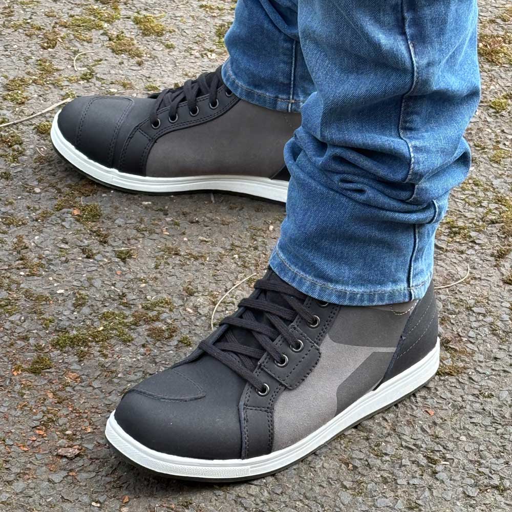 black and grey motorbike trainers with blue denim jeans for men