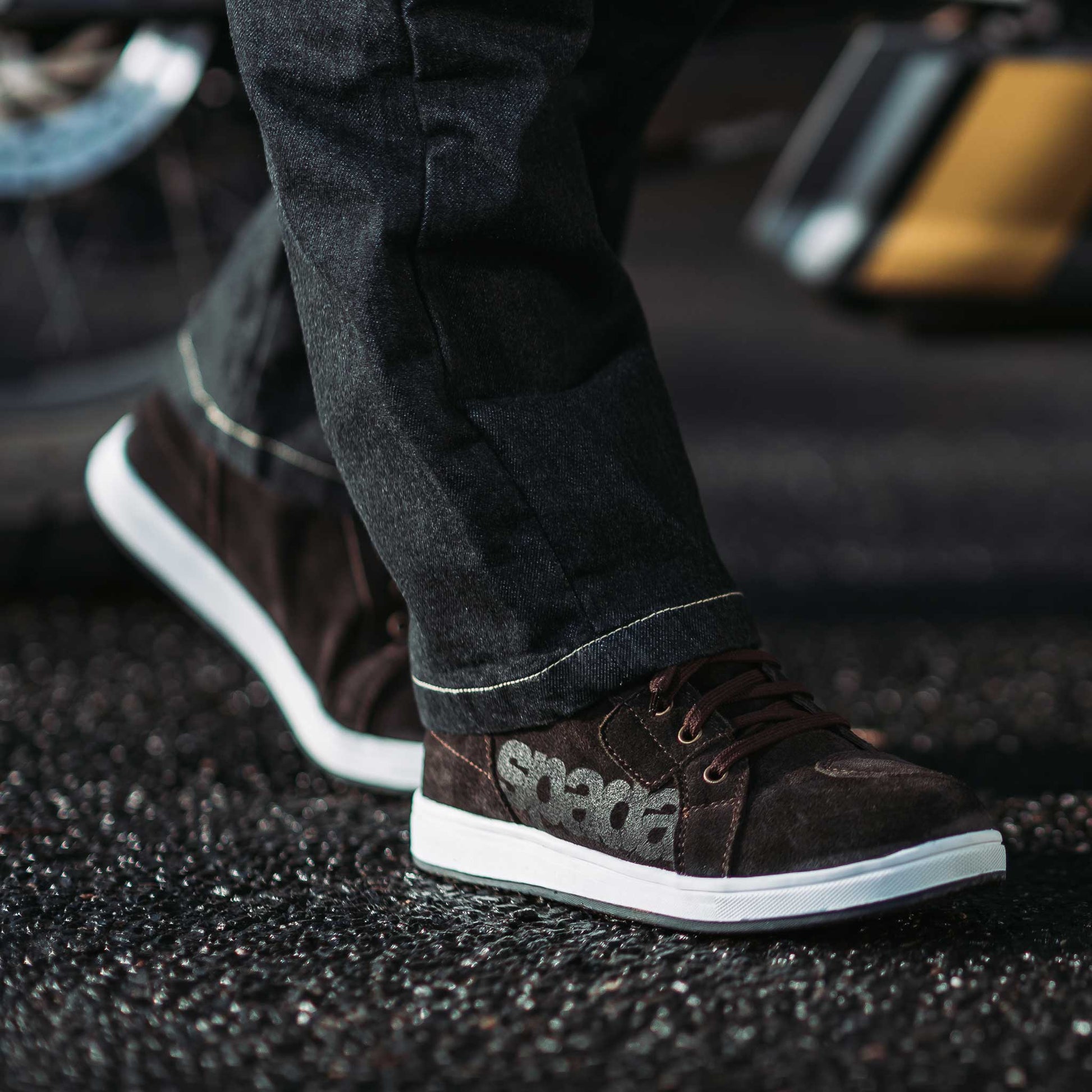 biker wearing jeans paired with brown high top trainers