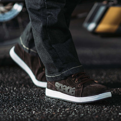 biker wearing jeans paired with brown high top trainers
