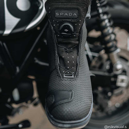 biker wearing black reflective motorcycle shoes on motorcycle while riding