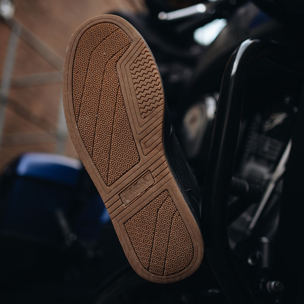 brown gum sole of black motorbike trainers
