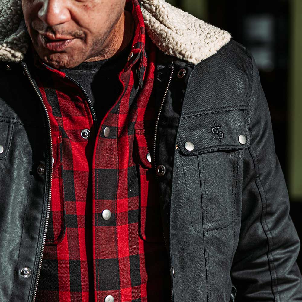 closeup of biker wearing black motorcycle jacket with level 2 protective armour