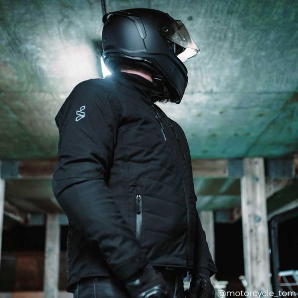 black quilted motorcycle jacket for men worn by biker with black motorcycle helmet