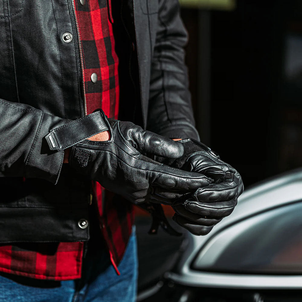 biker wearing classic black leather gloves with black leather jacket