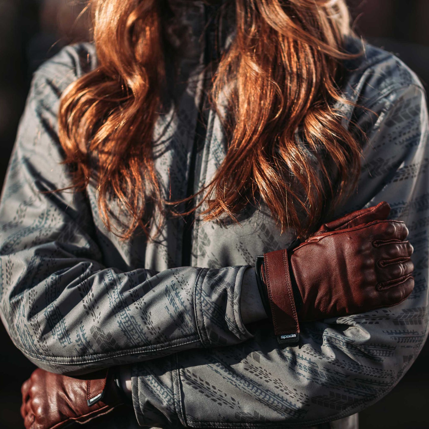 female biker wearing ladies motorcycle jacket with ladies gloves in brown