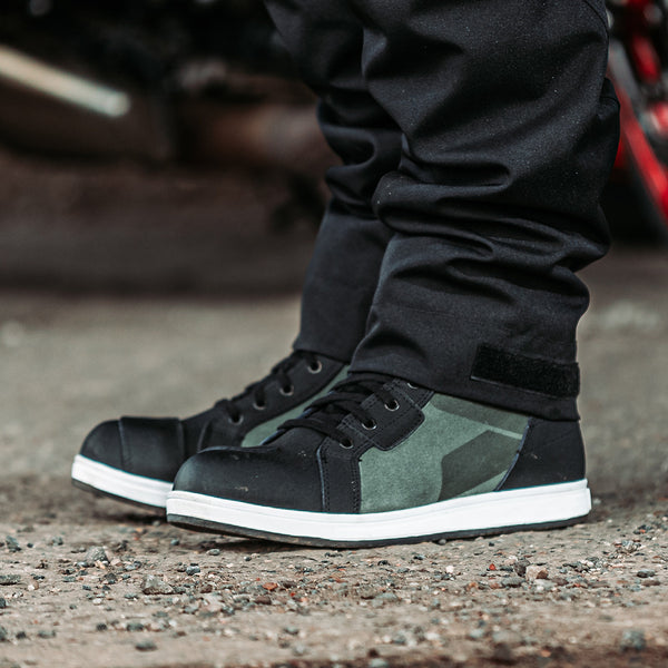 biker wearing a pair of black and green suede lace up high top motorbike boots