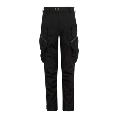 A pair of black Nodachi motorcycle trousers with protective armour, featuring multiple pockets, zip fasteners, and an adjustable waistband with a bungee cord and belt loops.