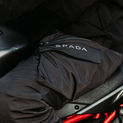 closeup of details on black waterproof motorcycle trousers with reflective spada logo